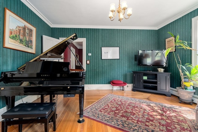 misc room featuring wood-type flooring, a baseboard radiator, crown molding, and a notable chandelier