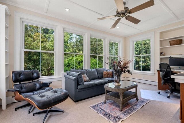 office space with baseboard heating, built in shelves, ceiling fan, and a healthy amount of sunlight