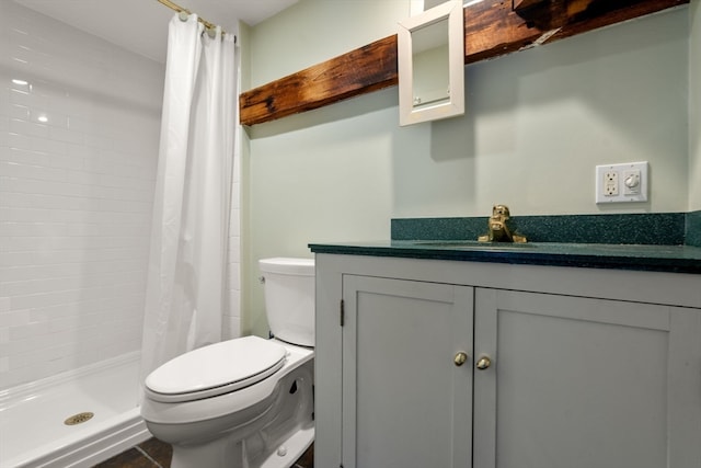 bathroom with curtained shower, tile patterned floors, toilet, and vanity