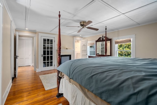 bedroom featuring ceiling fan, hardwood / wood-style flooring, and ornamental molding