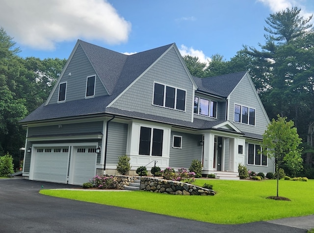 view of front of house featuring a front yard and a garage