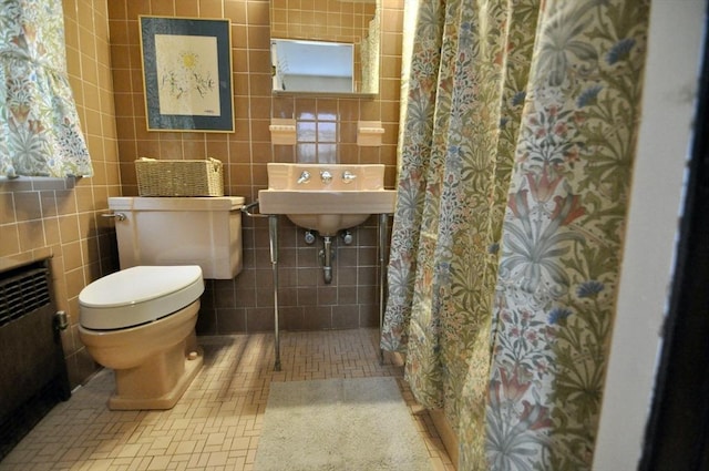 bathroom with walk in shower, radiator heating unit, tile walls, and toilet