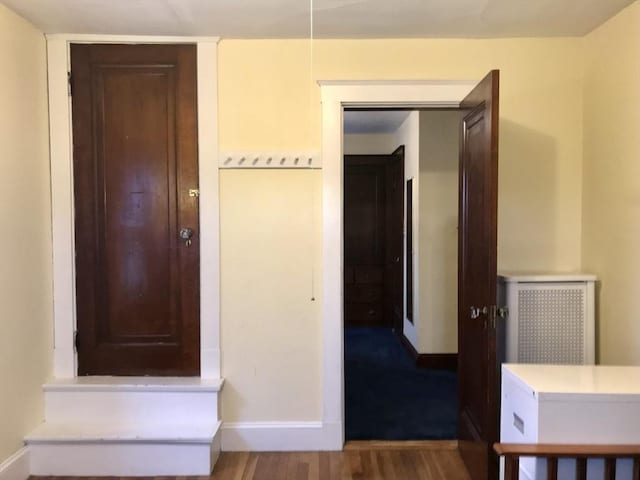 corridor with hardwood / wood-style flooring