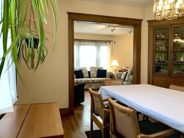 dining room featuring a chandelier and dark hardwood / wood-style floors