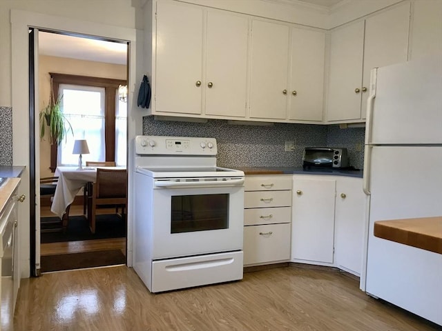 kitchen with white cabinets, decorative backsplash, light hardwood / wood-style floors, and white appliances