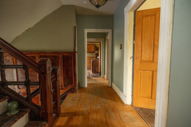 hallway with hardwood / wood-style flooring