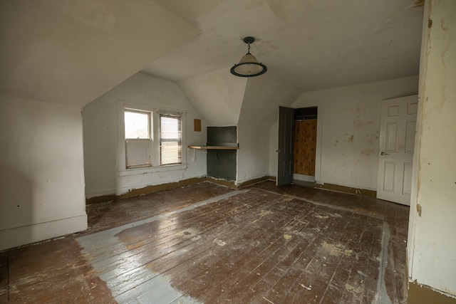 bonus room featuring dark hardwood / wood-style floors and vaulted ceiling