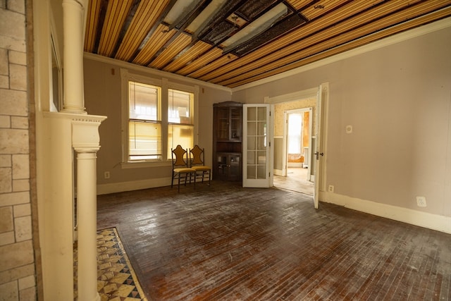 empty room featuring wood ceiling, crown molding, and dark hardwood / wood-style flooring