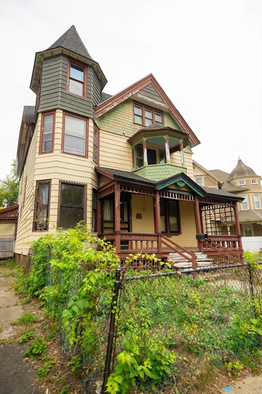 rear view of house featuring a porch