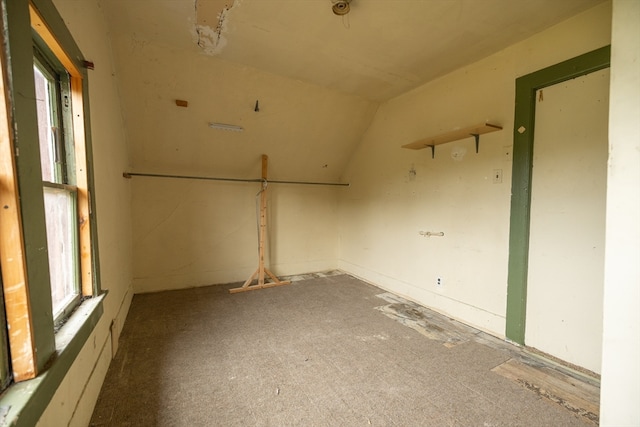 unfurnished room featuring lofted ceiling