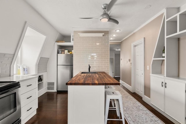 15 Beale St Unit 6, Boston, MA 02124 - kitchen featuring butcher block counters, open shelves, stainless steel appliances, a sink, and white cabinetry