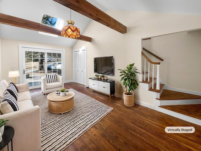 living room with beam ceiling, wood finished floors, a skylight, baseboards, and stairs