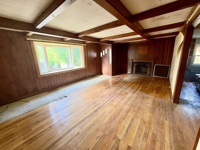 53 Morningside Path, Weymouth, MA 02189 - unfurnished living room featuring wooden walls, hardwood / wood-style floors, beamed ceiling, and a fireplace