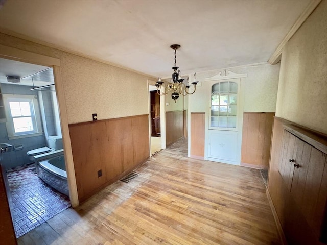 53 Morningside Path, Weymouth, MA 02189 - unfurnished dining area featuring a chandelier, a wainscoted wall, light wood finished floors, and crown molding