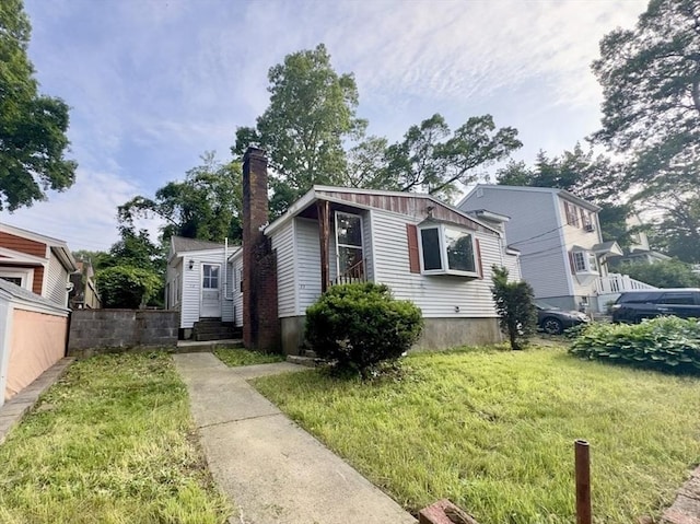 53 Morningside Path, Weymouth, MA 02189 - view of front of house featuring entry steps, a front yard, and a chimney