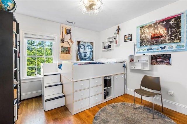 21 Hale St Unit 21, Newton, MA 02464 - bedroom featuring a baseboard heating unit and wood finished floors