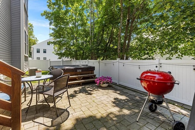 21 Hale St Unit 21, Newton, MA 02464 - fenced backyard featuring a hot tub, a patio, and area for grilling