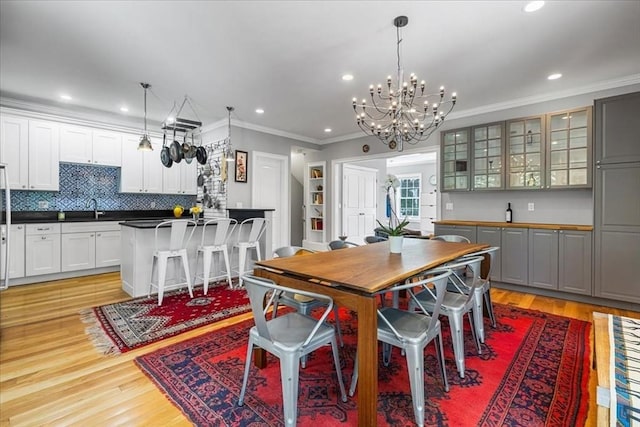 21 Hale St Unit 21, Newton, MA 02464 - dining room with crown molding, a chandelier, light wood-style flooring, and recessed lighting