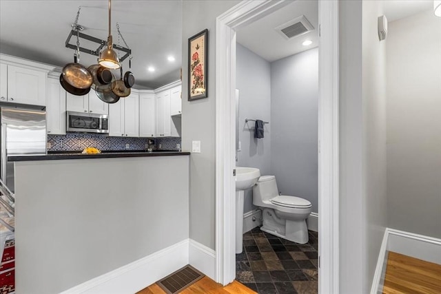 21 Hale St Unit 21, Newton, MA 02464 - bathroom featuring decorative backsplash, stone finish flooring, and recessed lighting