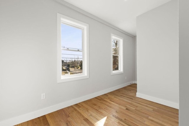 unfurnished room featuring light wood-type flooring and a wealth of natural light