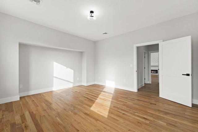 unfurnished room with hardwood / wood-style flooring