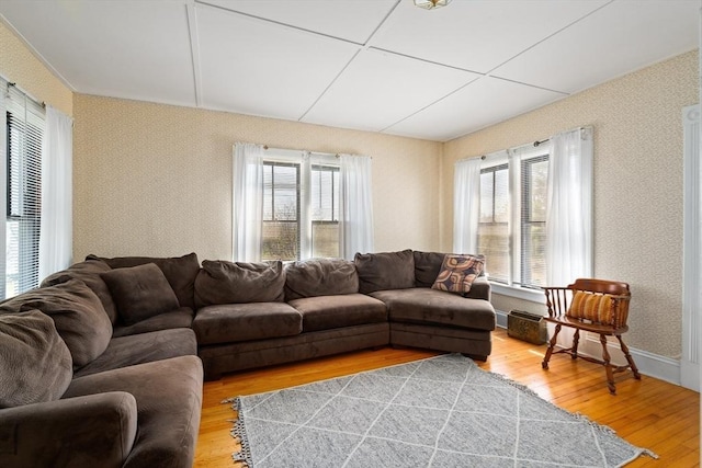 living room featuring light wood-style floors and wallpapered walls
