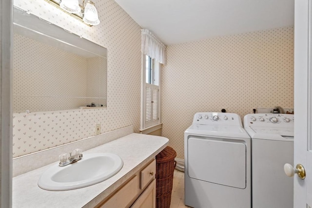 bathroom with washer and dryer, wallpapered walls, and vanity