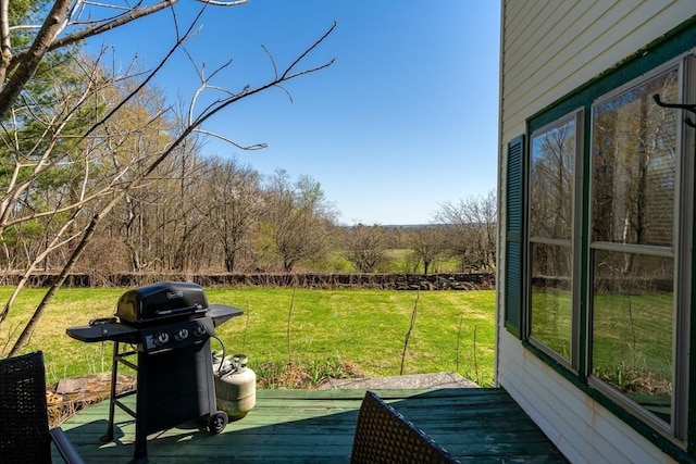 wooden deck featuring a yard and area for grilling