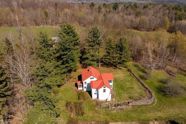birds eye view of property with a view of trees