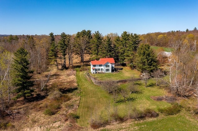birds eye view of property with a forest view