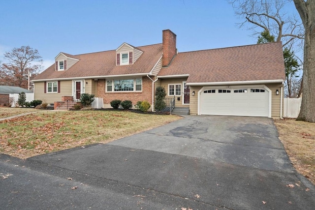 cape cod home featuring a front lawn and a garage