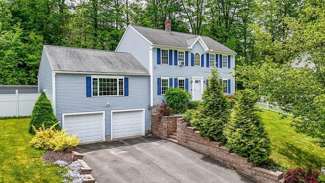 37 Sylvan Rd, Gardner, MA 01440 - colonial inspired home featuring driveway, roof with shingles, a garage, view of wooded area, and a chimney