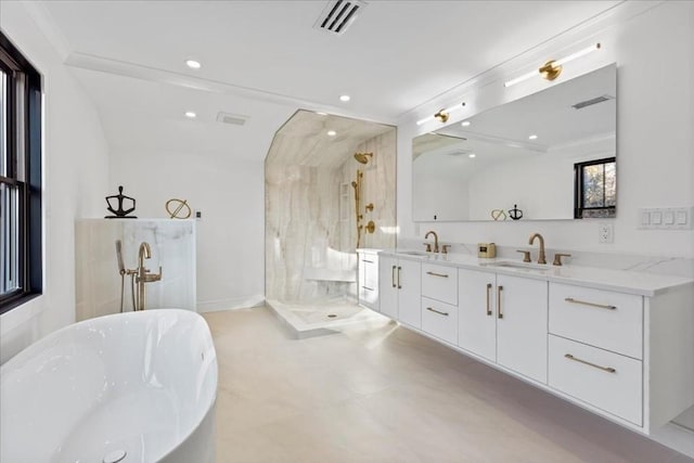 full bath featuring visible vents, a shower stall, double vanity, a soaking tub, and a sink