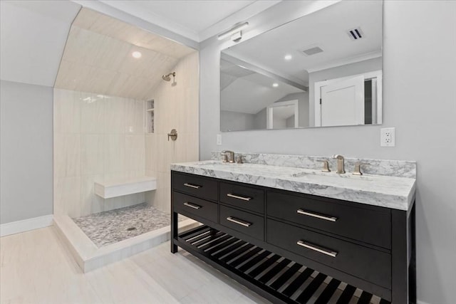 full bathroom featuring double vanity, vaulted ceiling, a walk in shower, and a sink