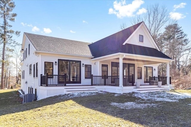 view of front facade featuring a porch, a front yard, and a shingled roof