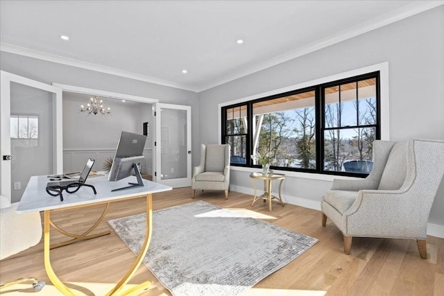 sitting room featuring wood finished floors, baseboards, recessed lighting, crown molding, and a chandelier