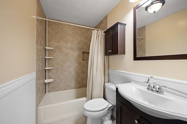 full bathroom with shower / bath combo, toilet, vanity, and tile patterned floors