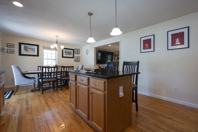 22 Hartley Ave, Brockton, MA 02302 - kitchen with brown cabinets, wood finished floors, and pendant lighting