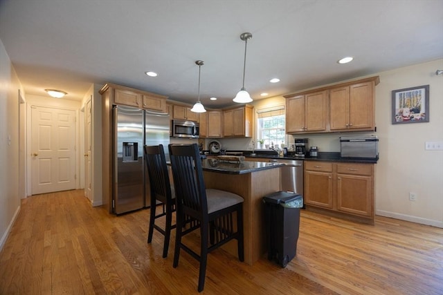 22 Hartley Ave, Brockton, MA 02302 - kitchen with stainless steel appliances, dark countertops, a kitchen bar, light wood finished floors, and recessed lighting