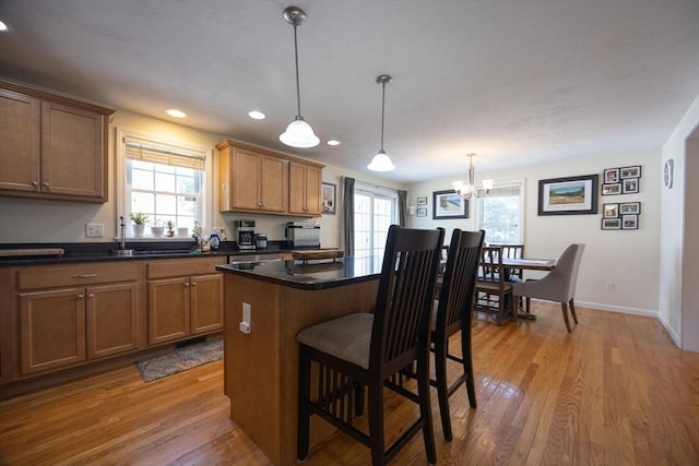 22 Hartley Ave, Brockton, MA 02302 - kitchen with light wood-style floors, a breakfast bar area, healthy amount of natural light, dark countertops, and recessed lighting