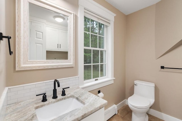 21 Autumn Ln, Marion, MA 02738 - half bathroom with a baseboard heating unit, toilet, baseboards, tile patterned floors, and vanity