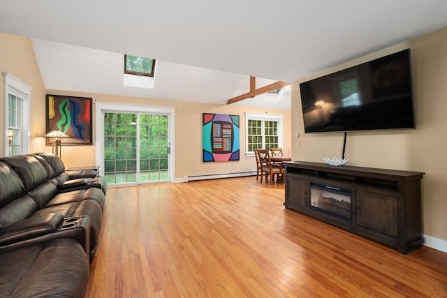 21 Autumn Ln, Marion, MA 02738 - living room featuring light wood-style flooring, a skylight, baseboard heating, plenty of natural light, and vaulted ceiling