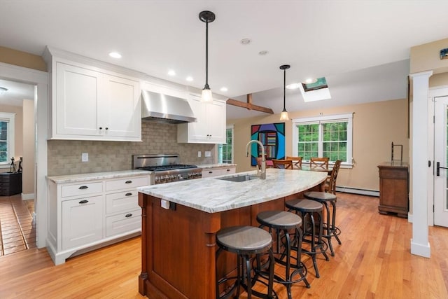 21 Autumn Ln, Marion, MA 02738 - kitchen with a sink, wall chimney exhaust hood, range, a baseboard heating unit, and a skylight