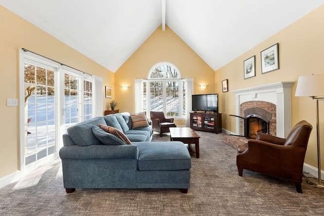 carpeted living room featuring beamed ceiling, a brick fireplace, and high vaulted ceiling