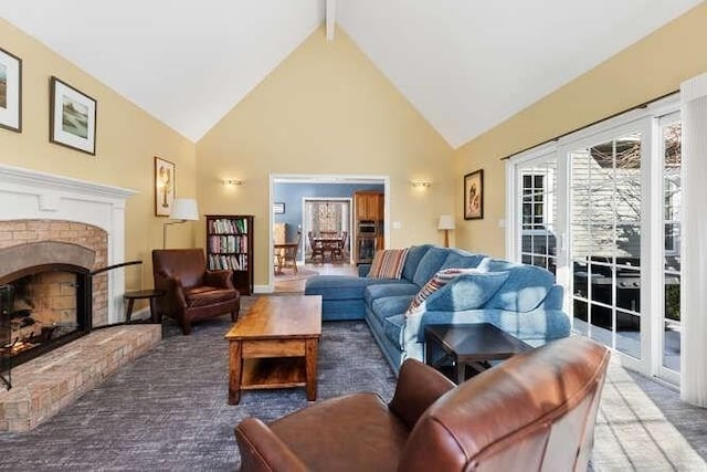 living room with beamed ceiling, carpet flooring, high vaulted ceiling, and a brick fireplace