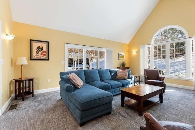 carpeted living room featuring high vaulted ceiling