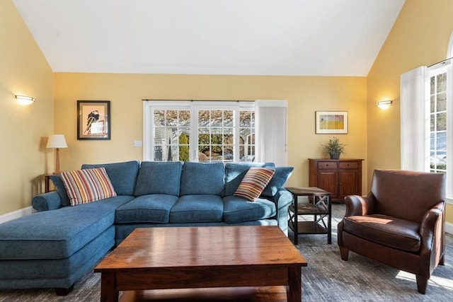 carpeted living room featuring lofted ceiling