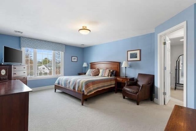 bedroom featuring light carpet