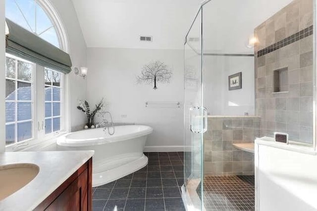 bathroom with tile patterned floors, vanity, shower with separate bathtub, and lofted ceiling