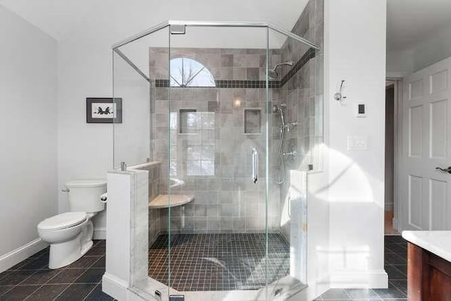 bathroom with vanity, toilet, an enclosed shower, and tile patterned flooring